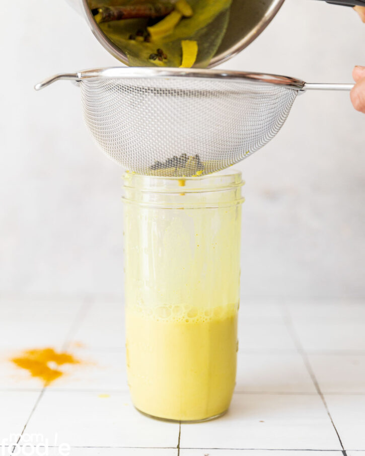 Strain the spices out of the drink with a wire mesh colander.