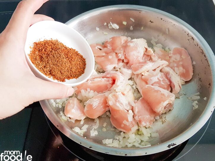 add chicken and Cajun seasoning to the pan