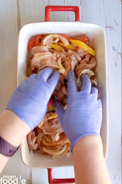 Mixing in seasoning with gloves