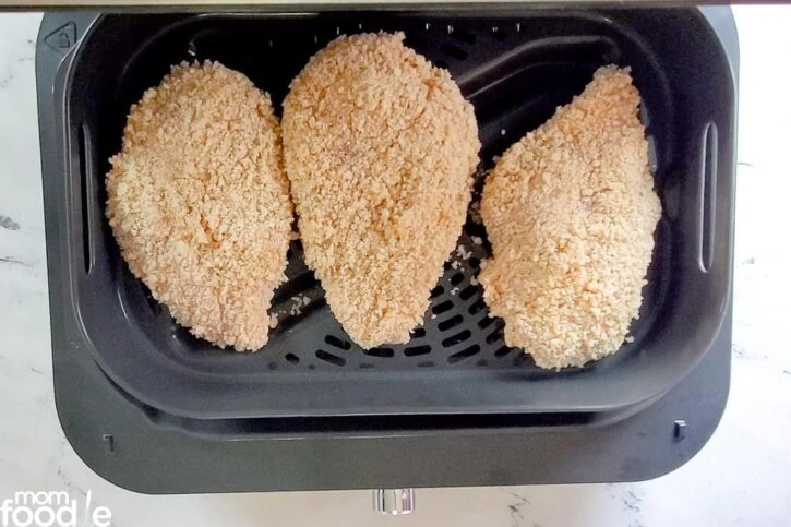 raw chicken in air fryer basket