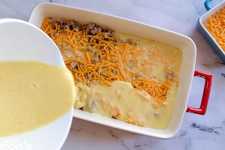 pour egg mixture over the cooked sausage and cheese