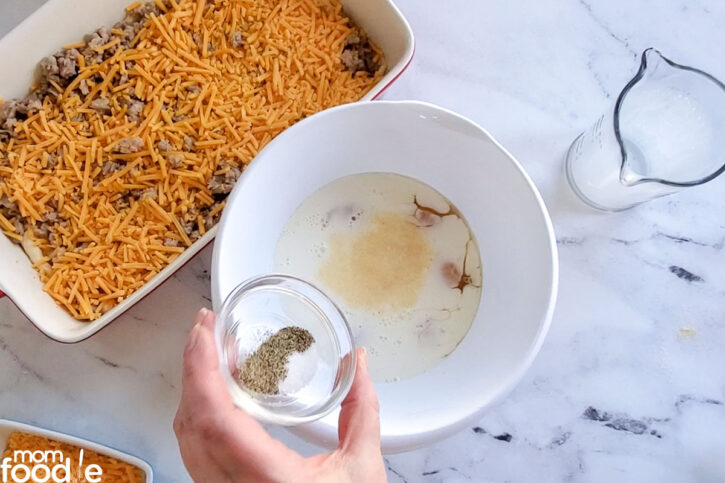 add seasonings to milk and eggs, shown in large bowl in front of the baking dish