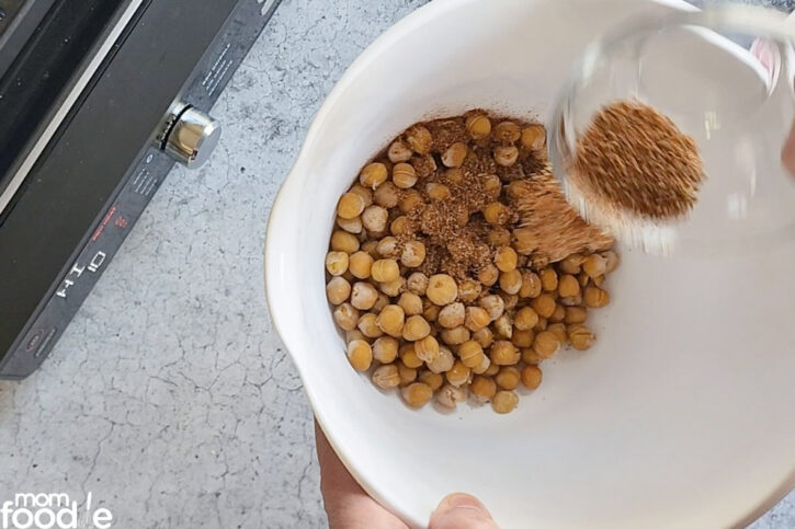 add seasonings to the bowl of chickpeas