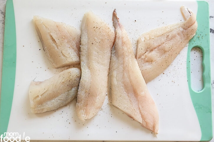 haddock fish fillets cut into serving sized pieces and topped with Kosher salr and fresh ground black pepper