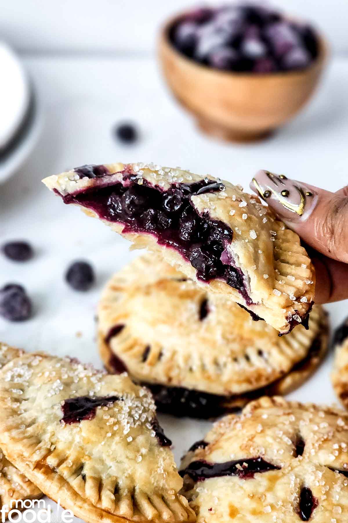 half a blueberry hand pie showing the blueberry filling.