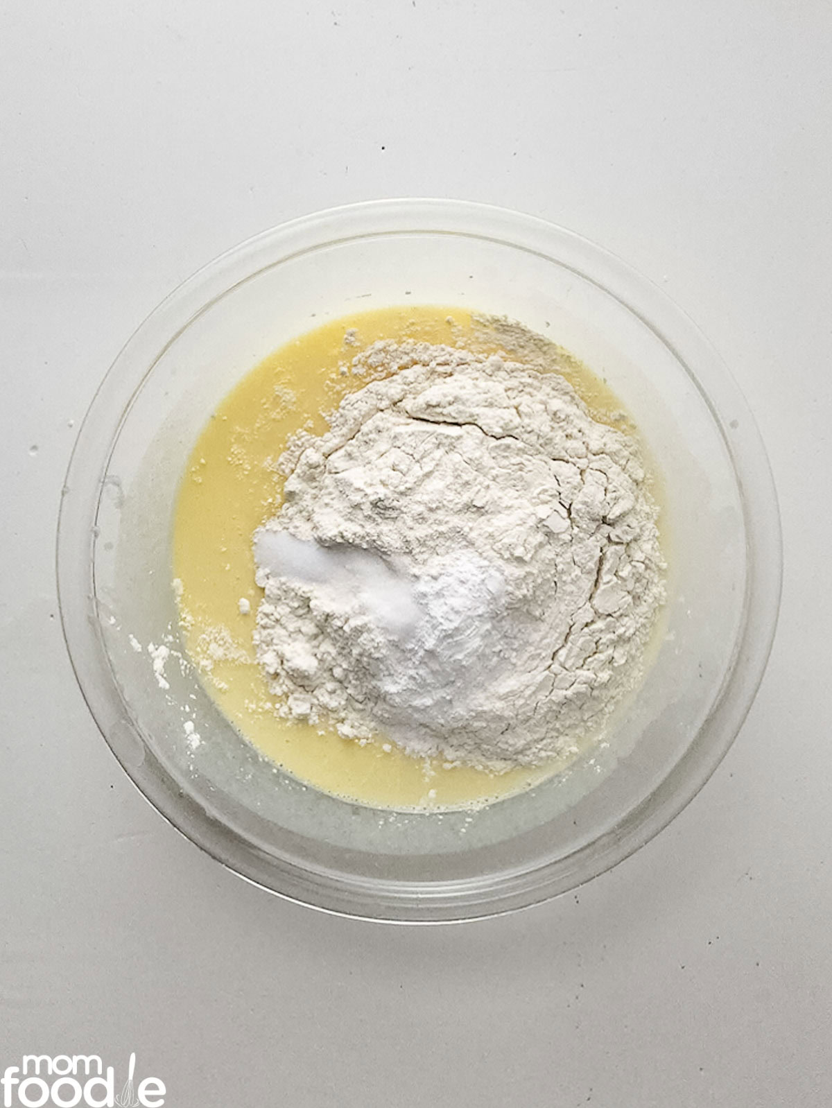 adding dry ingredients to the lemon cake batter
