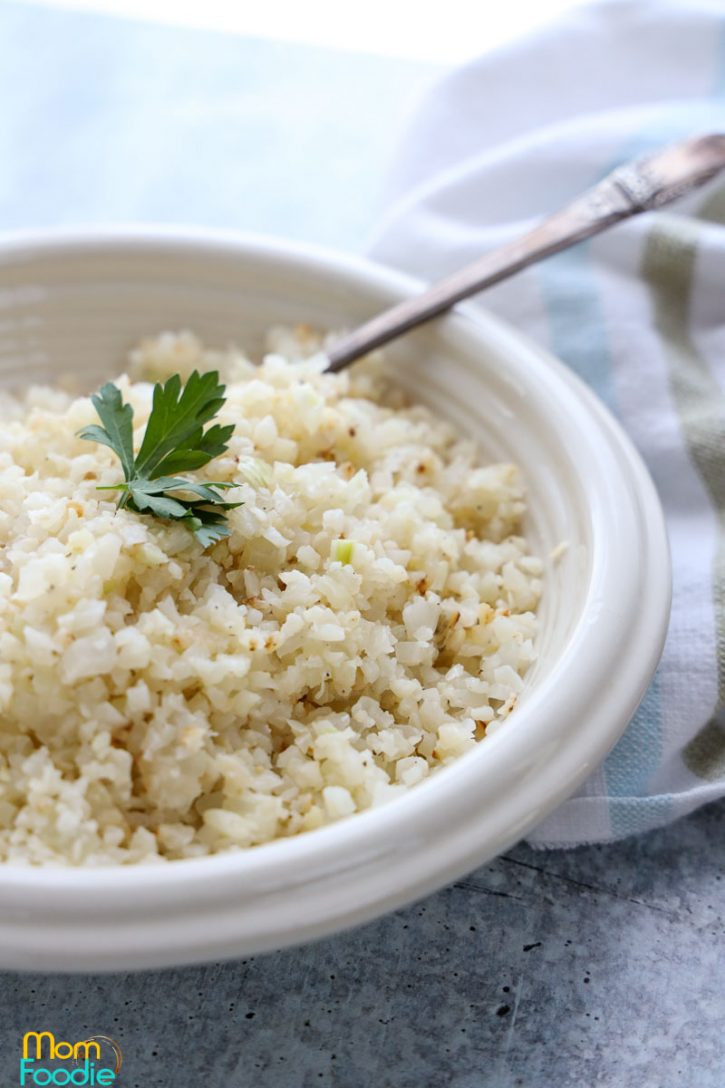 frozen cauliflower rice recipe for pilaf served in white bowl.