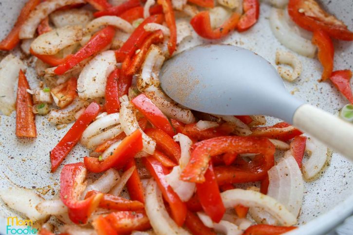 saute bell peppers and onion slices with hot oil in large skillet.