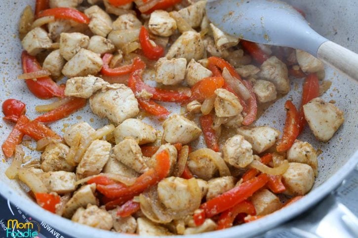 cooked fajita seasoned chicken with sliced peppers