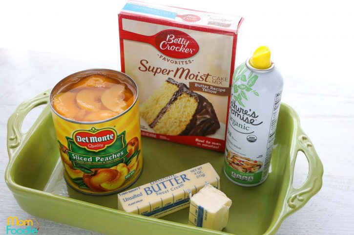 3 ingredients dump cake, peaches, dry cake mix, unsalted butter with casserole dish and cooking spray