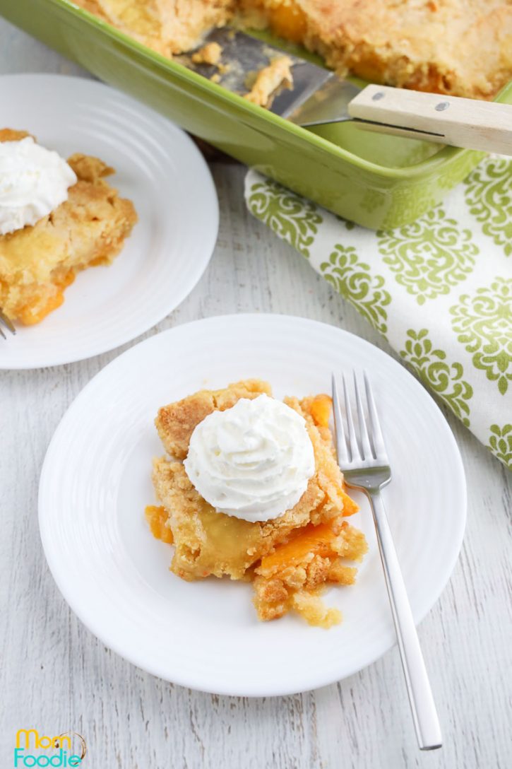 Peach Cobbler Dump Cake with whipped cream on top