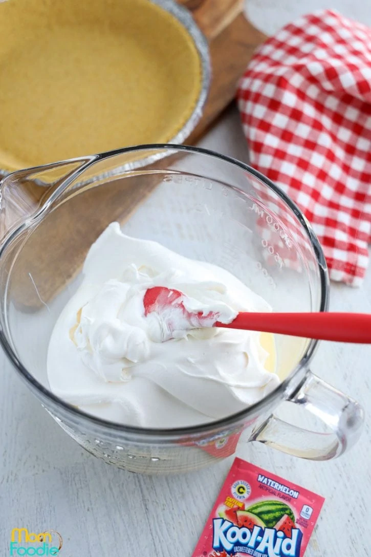 whipped topping and sweetened condensed milk in mixing bowl.