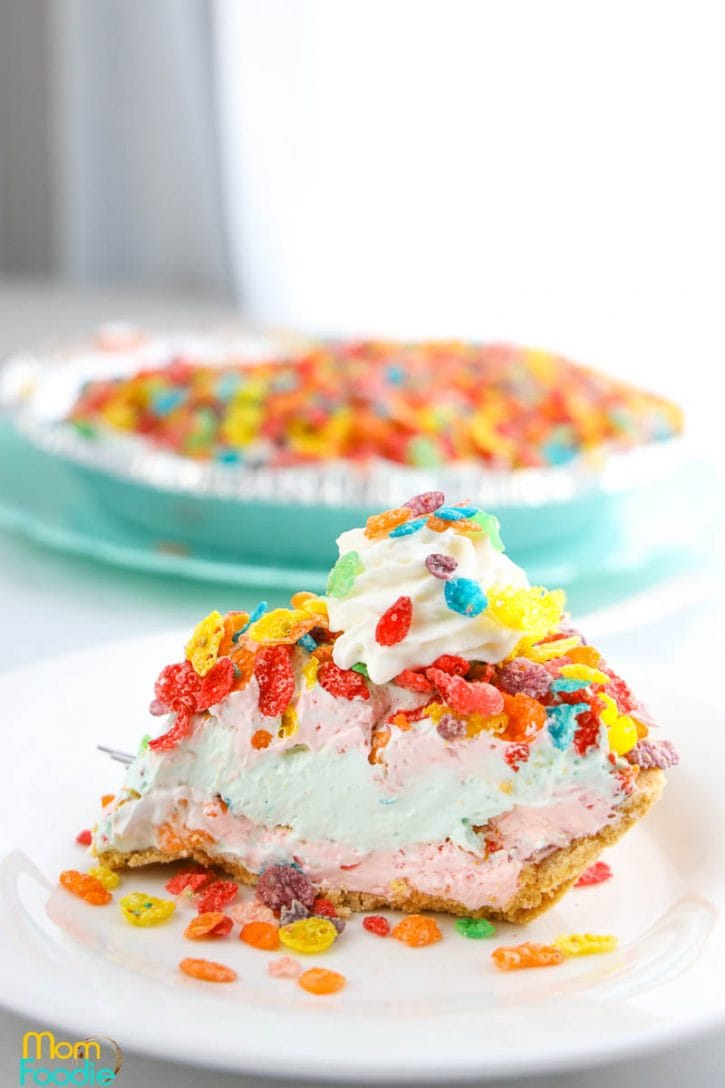 Fruity Pebbles Pie with layers of different color filling and colorful cereal.