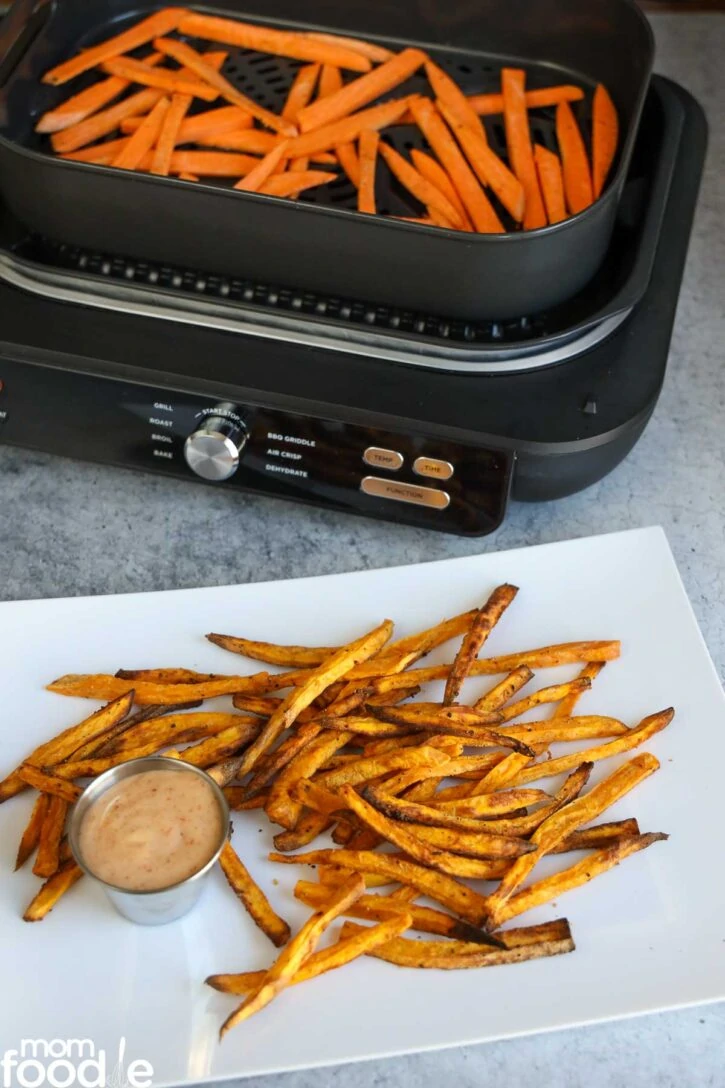 Making air fried sweet potato fries in batches.