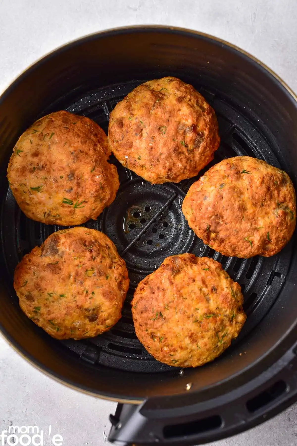 lightly browned salmon cakes in air fryer oven