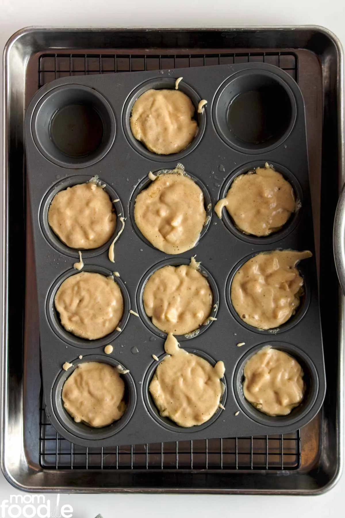 Scoop fritter dough into muffin pan.
