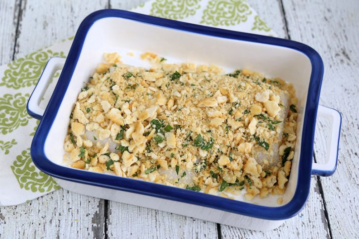 Cod ready for oven with garlic and crumb stuffing over it.