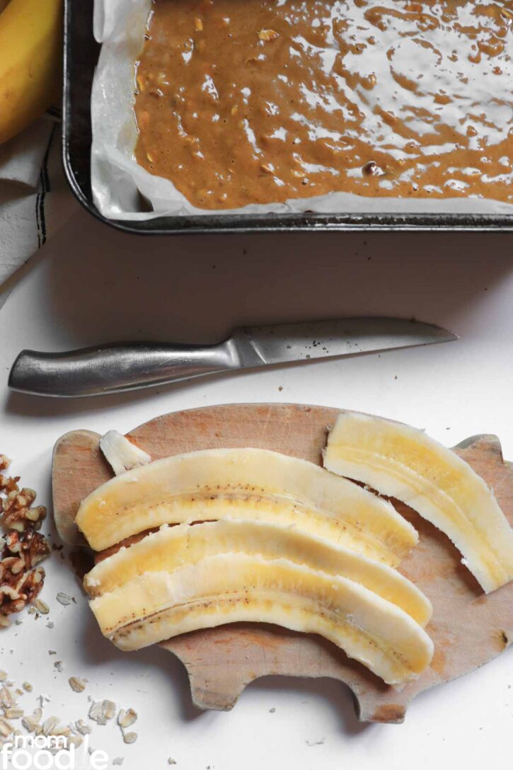 long sliced bananas on cutting board.