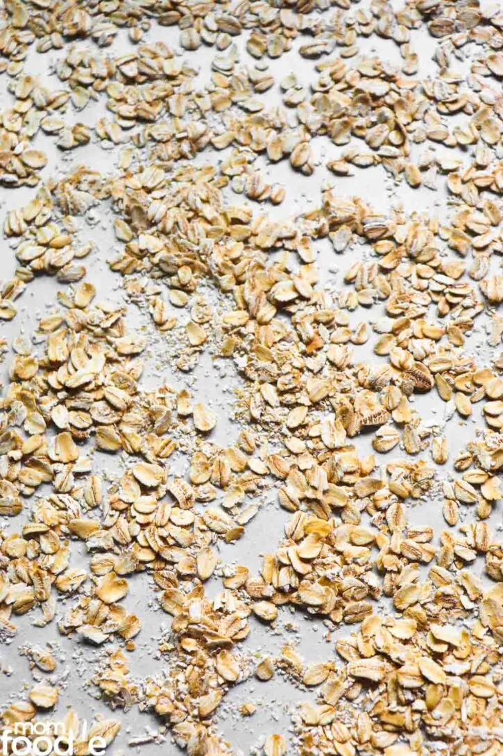 toasting oats on lined sheet pan.