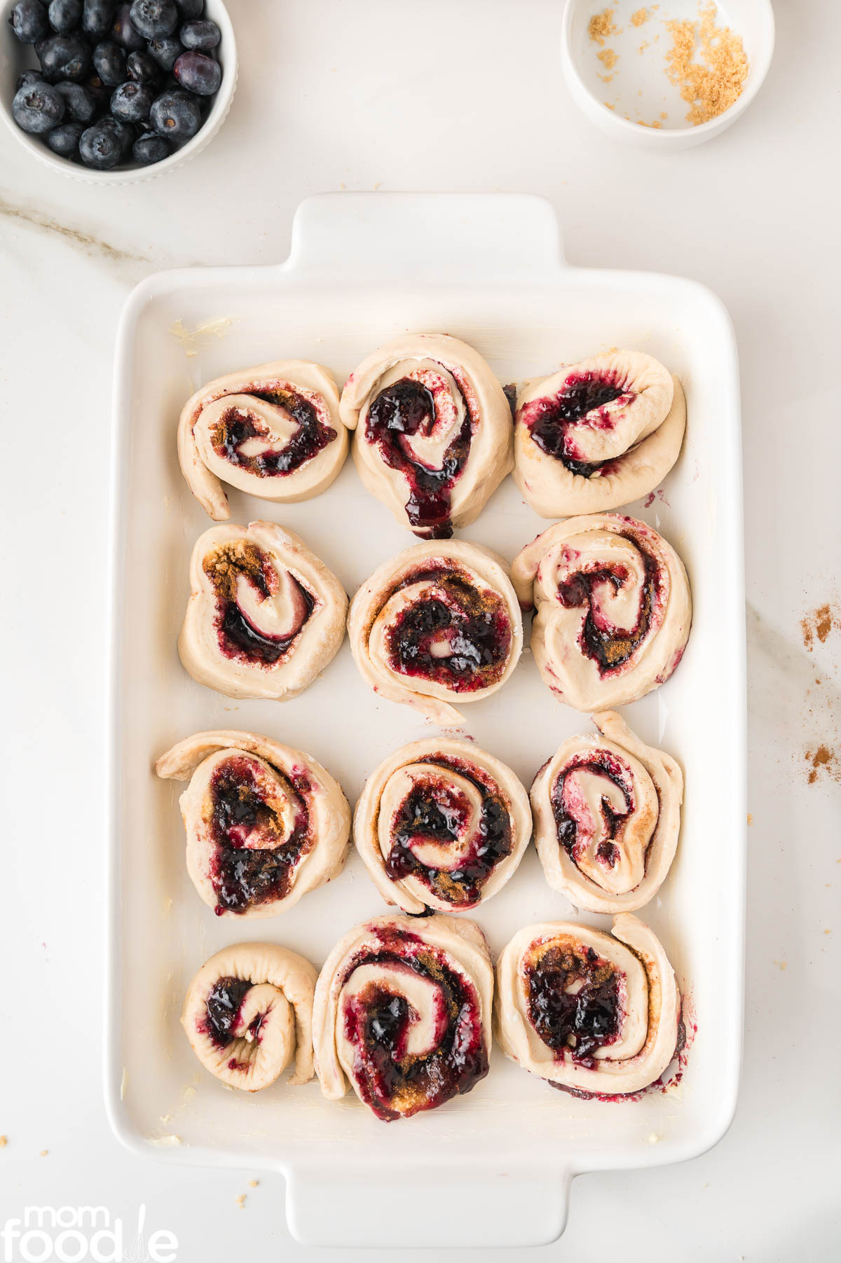 cut rolls placed in baking dish to rise