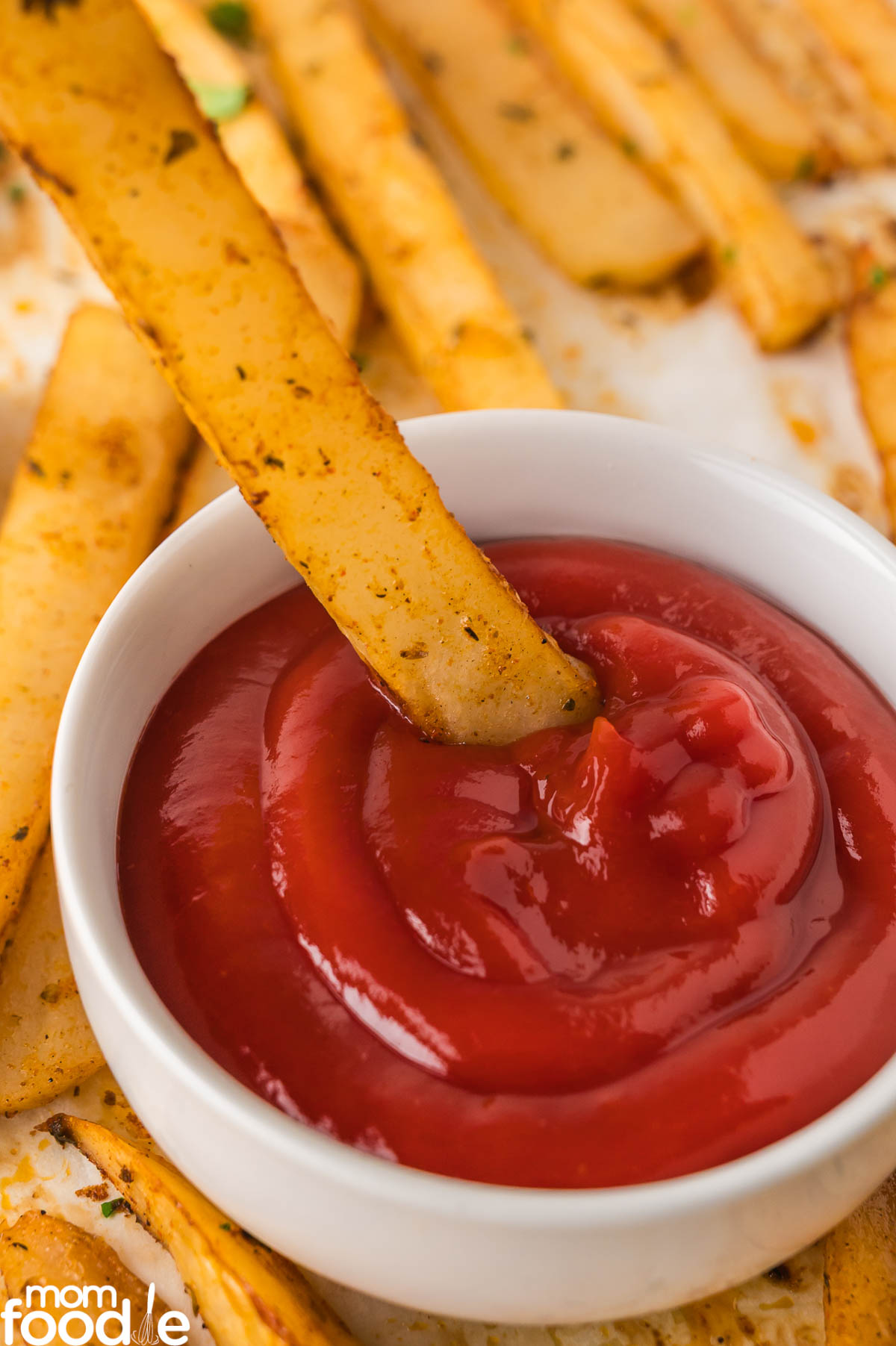 dunking Cajun Fry in ketchup