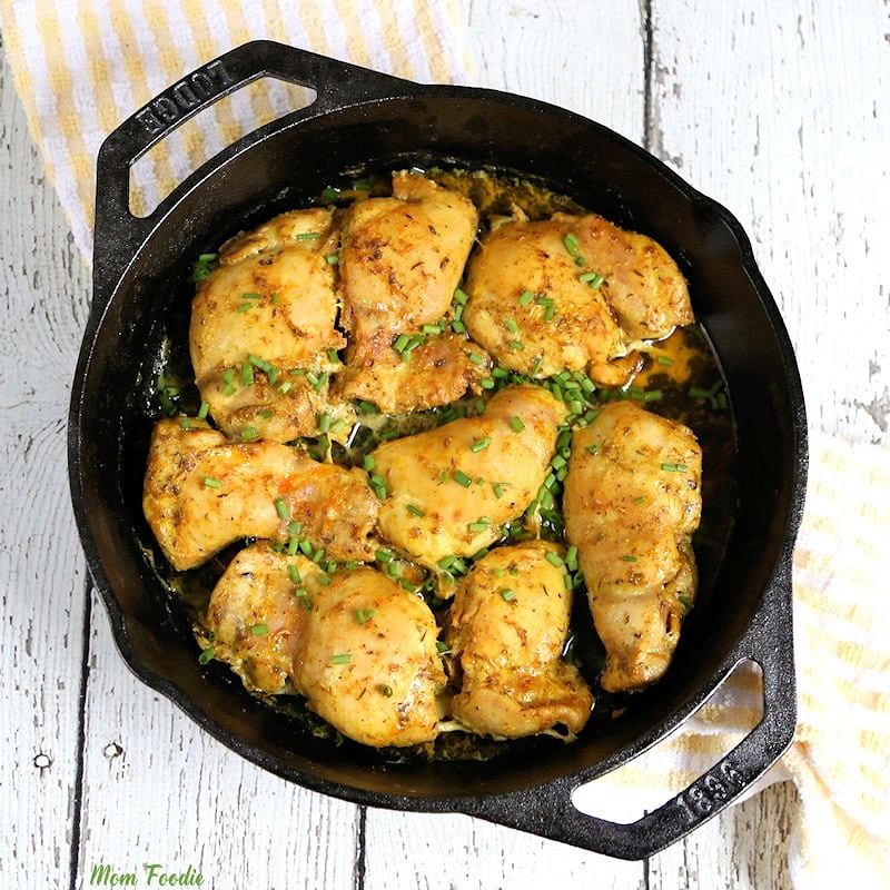 baked turmeric chicken in cast iron skillet