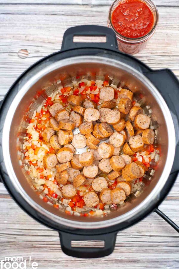 Kielbasa with peppers and onions being sauteed in the pressure cooker.