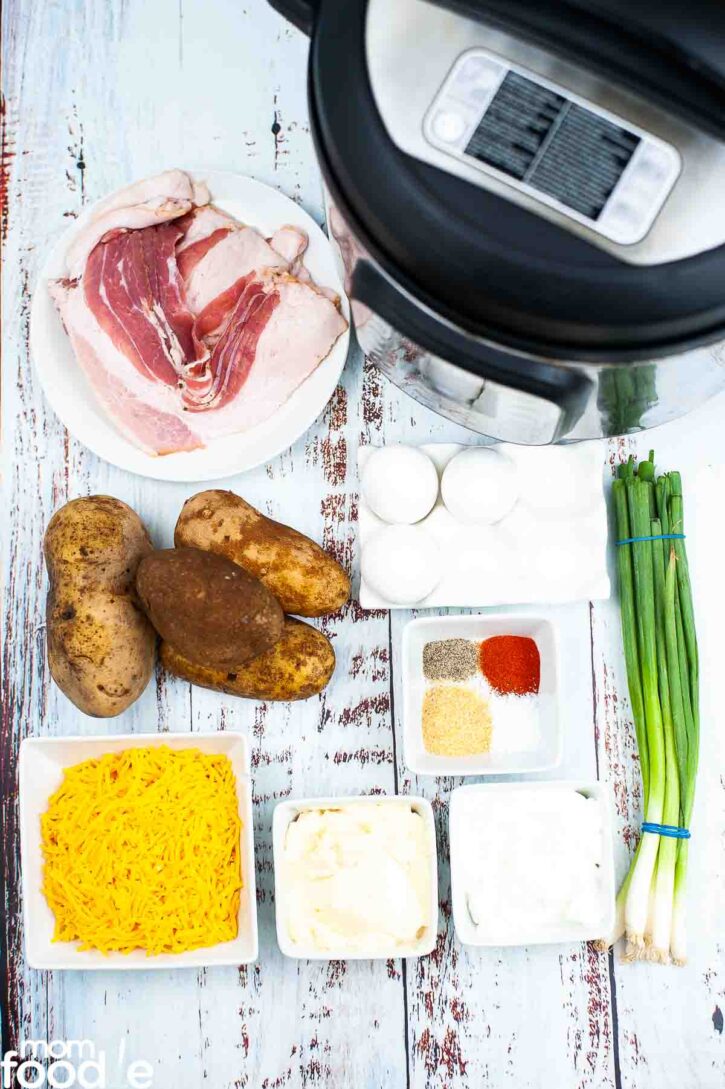 ingredients for potato salad on wood backdrop.
