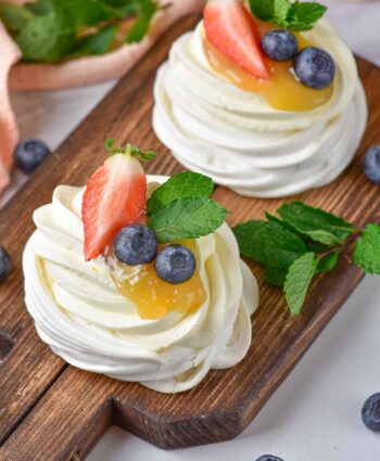 strawberries and blueberries on pavlovas