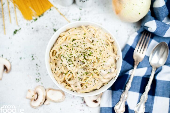white bowl filled with the creamy chicken pasta with mushrooms, instant pot chicken tetrazzini