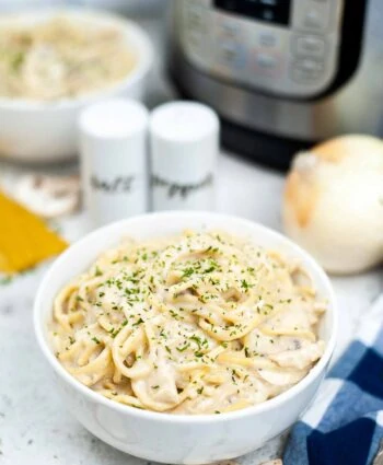 Instant Pot Chicken Tetrazzini in front of electric pressure cooker.