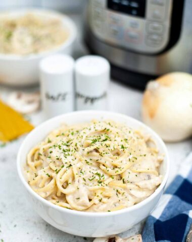 Instant Pot Chicken Tetrazzini in front of electric pressure cooker.