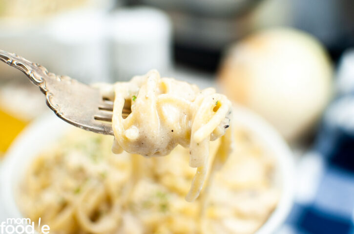 Eating Chicken Tetrazzini Instant Pot recipe, twirled on fork.