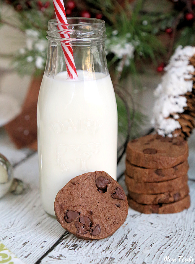 chocolate shortbread Cookies with milk in front of Christmas tree