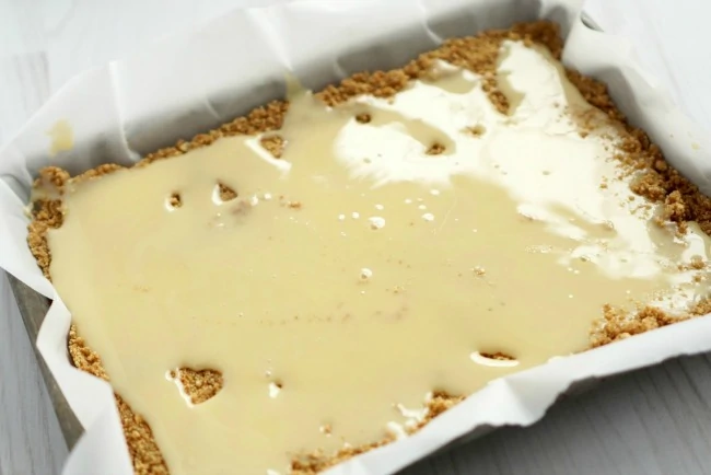 the condensed milk spread out over the  crust