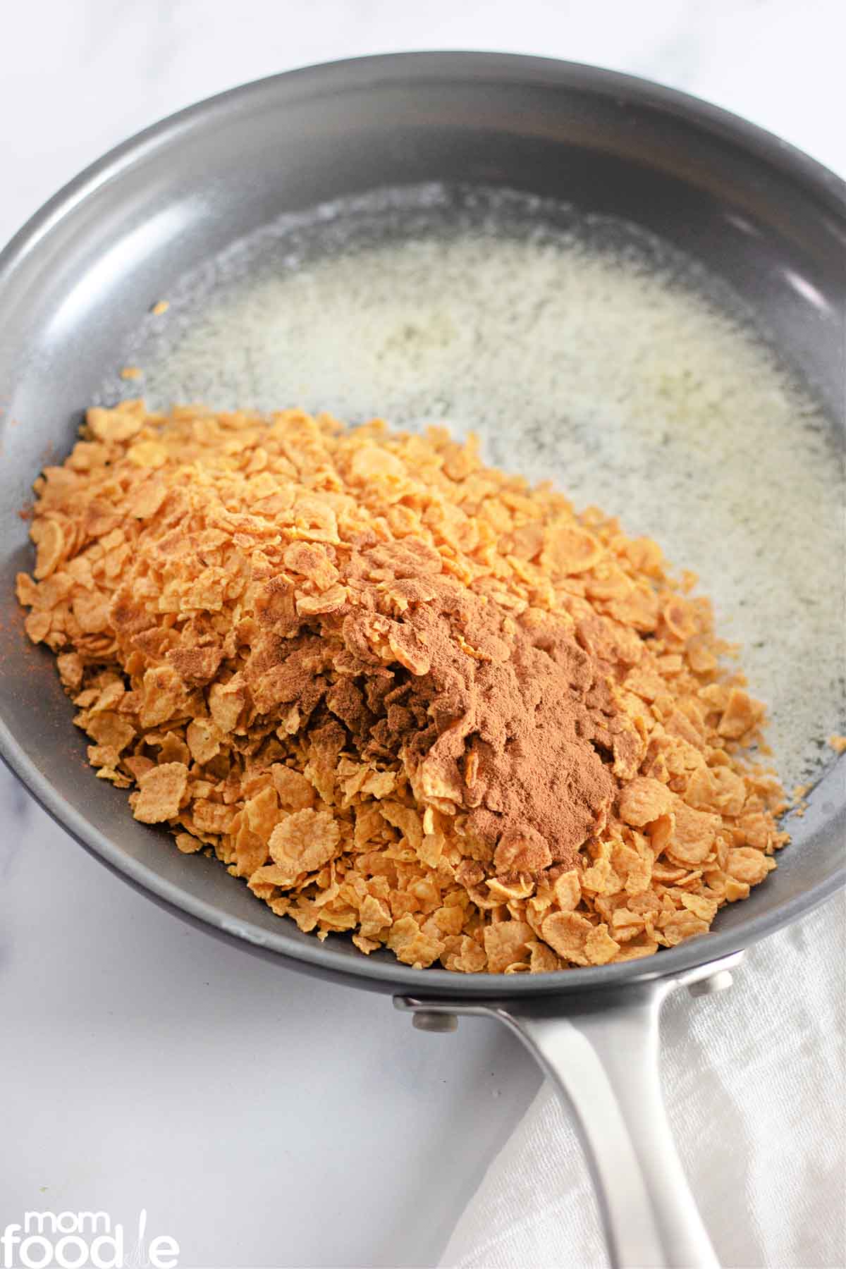 crushed corn flakes and cinnamon in skillet with melted butter