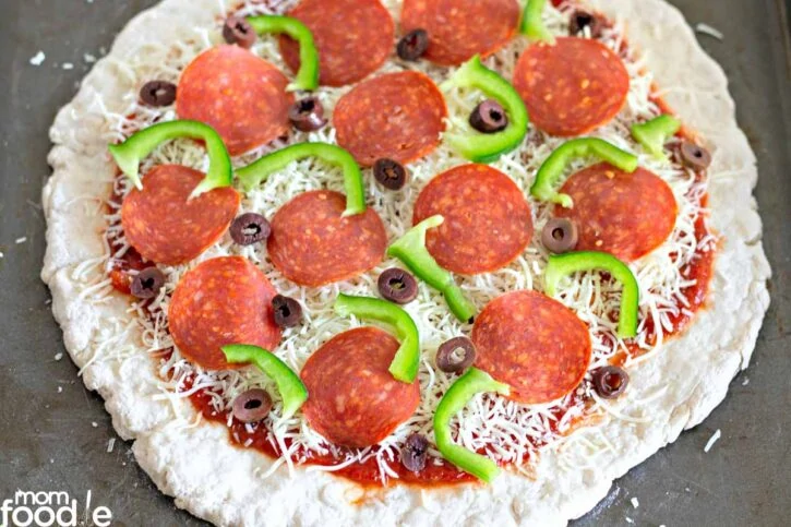 Favorite toppings added to the unbaked crust.