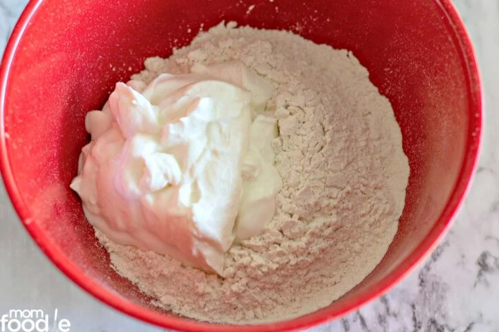 Flour and yogurt in a large mixing bowl.