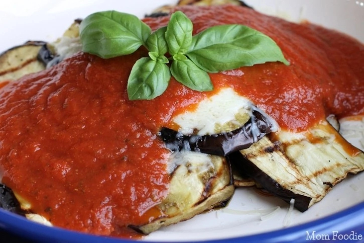 Low carb eggplant recipe keto-friendly plated with basil leaf.