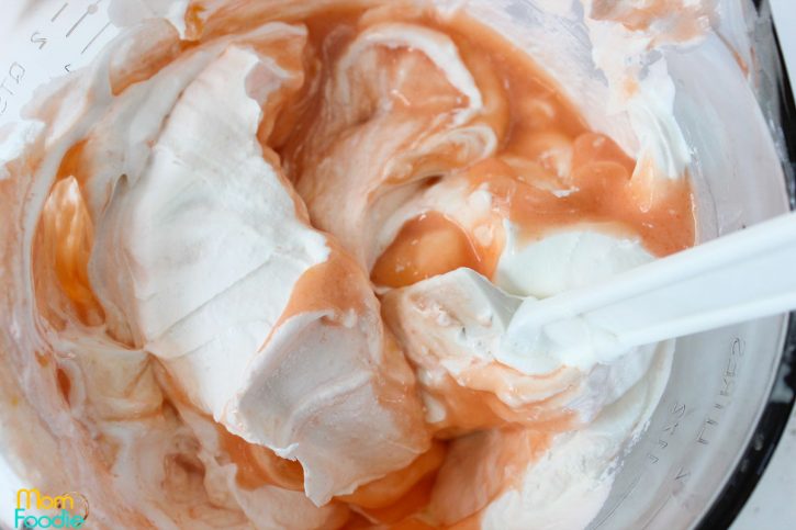 adding whipped topping to peach filling