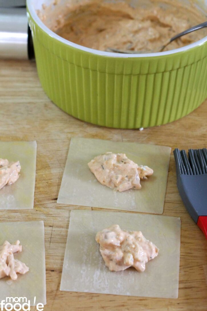 buffalo chicken ranch cream cheese filling scooped on wonton wrappers