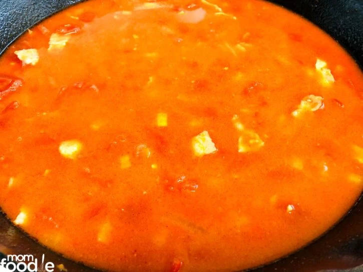 Flour, tomatoes, chicken broth and salt and pepper mixed to make base of sauce in bottom of the pan.
