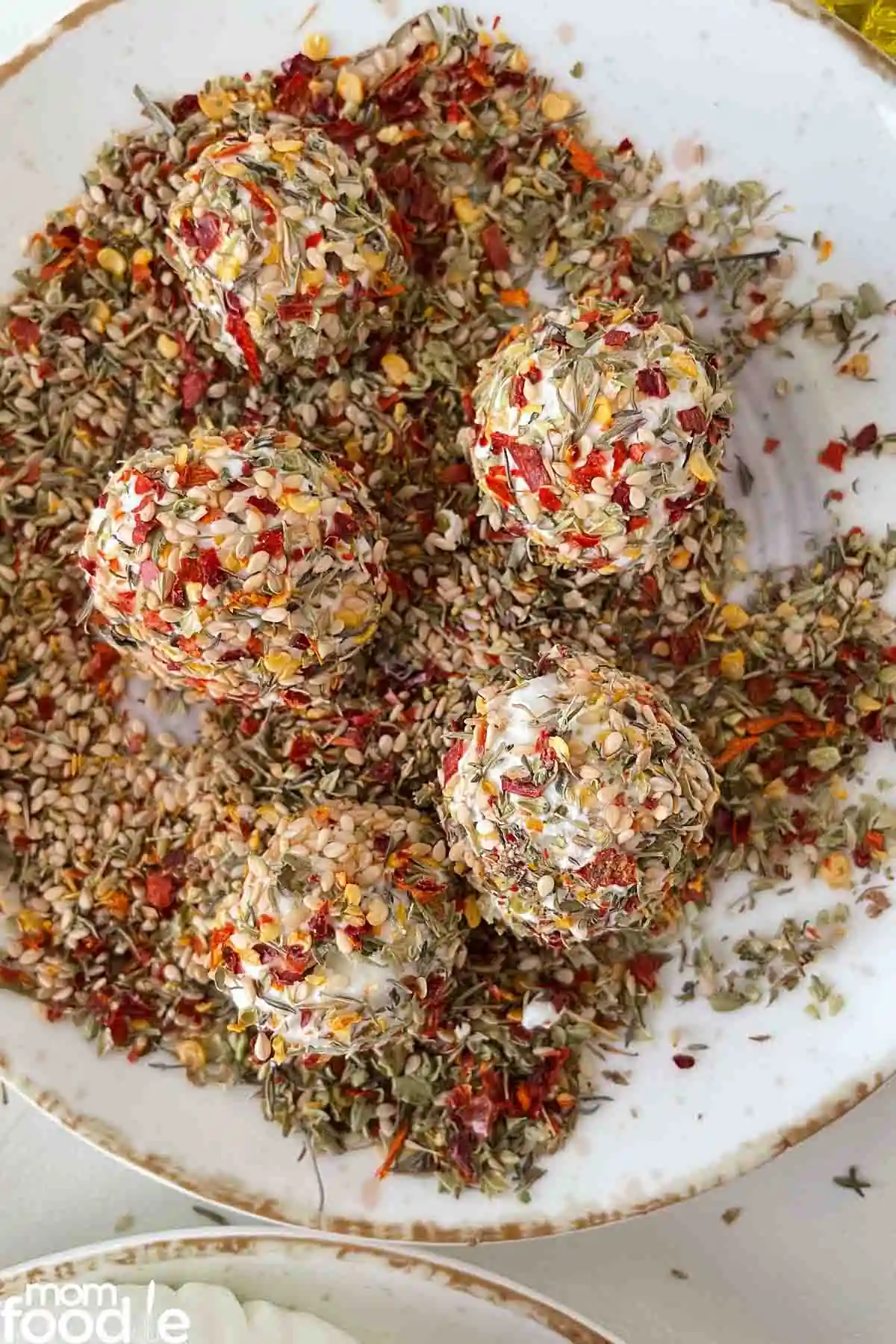 rolling the labneh in spice mixture.