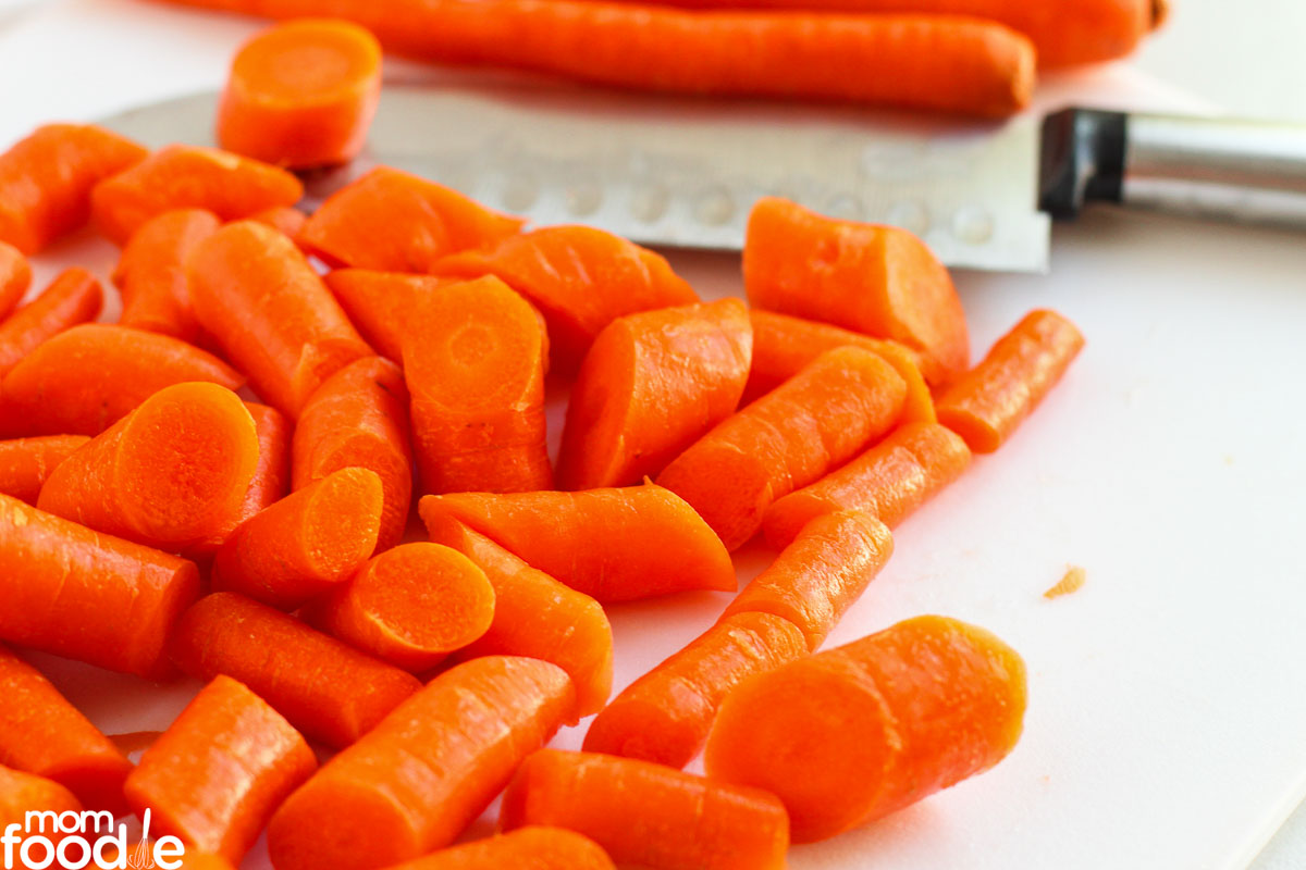 sliced carrots on cutting board with knife