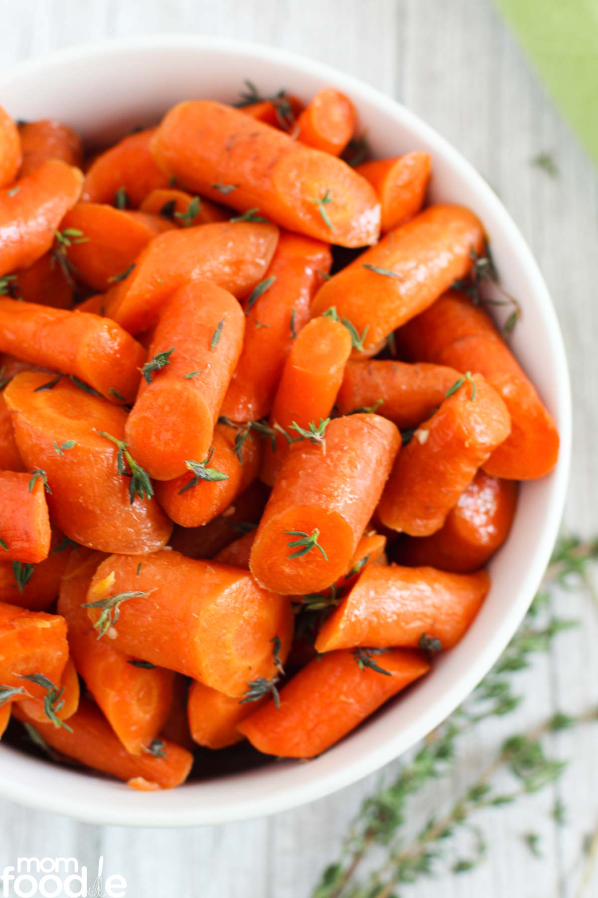 brown sugar glazed carrots in white serving bowl