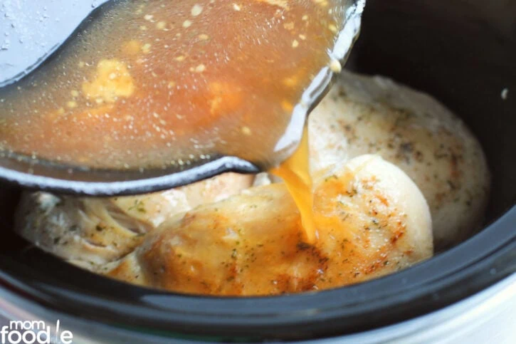 pour broth over chicken.