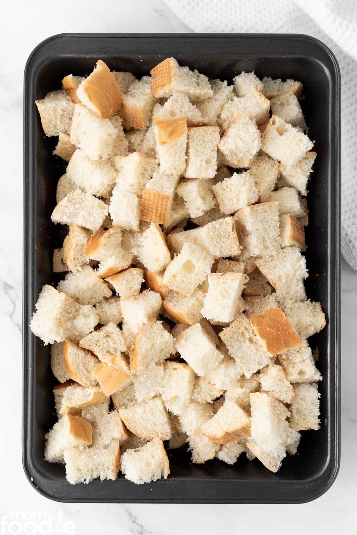 spread bread cubes evenly in pan