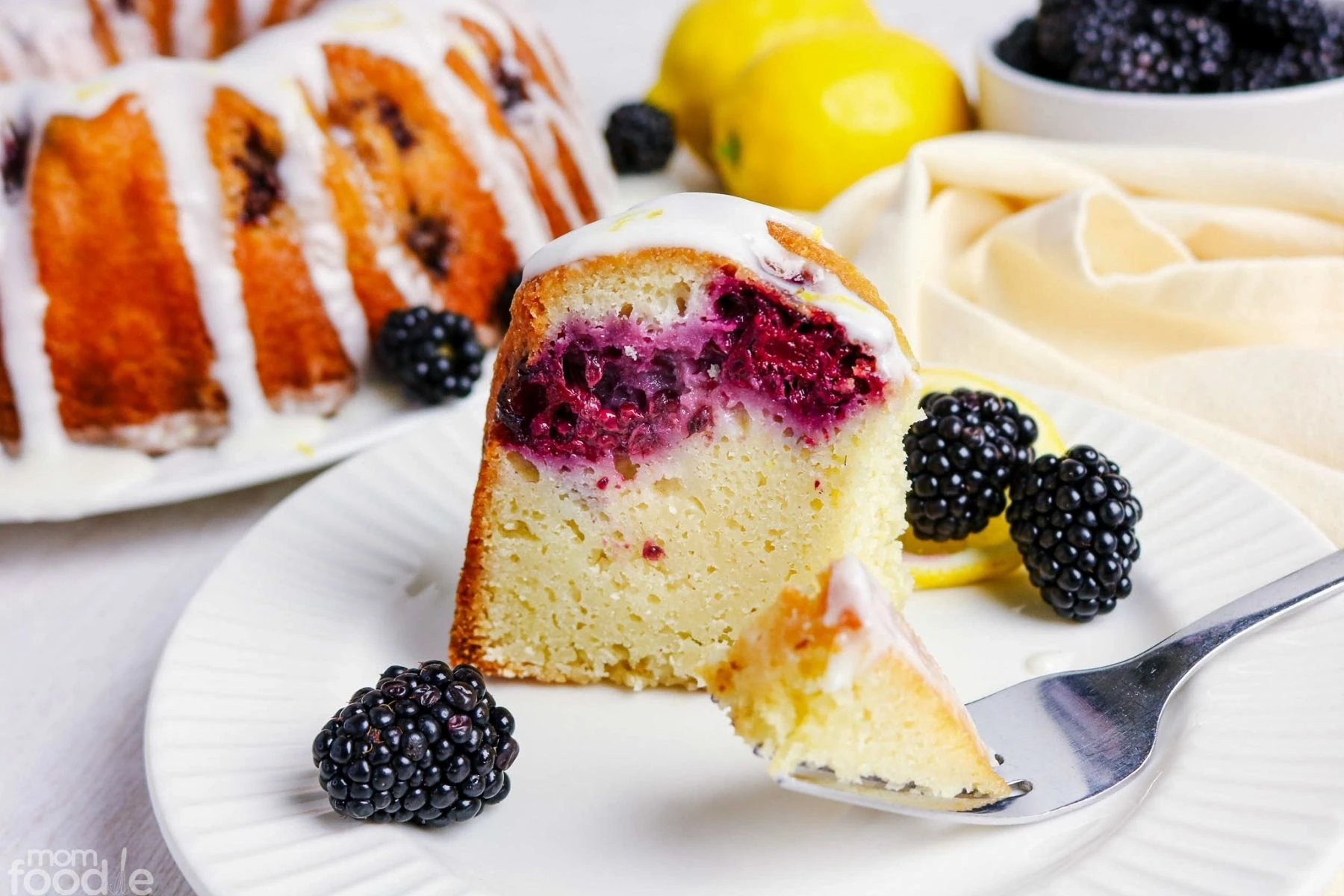 Lemon blackberry Bundt cake slice on dessert plate