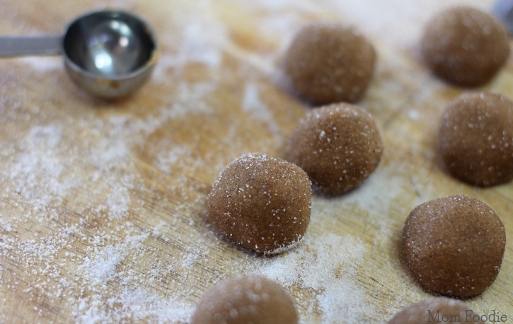 rolling cookie dough balls in sugar