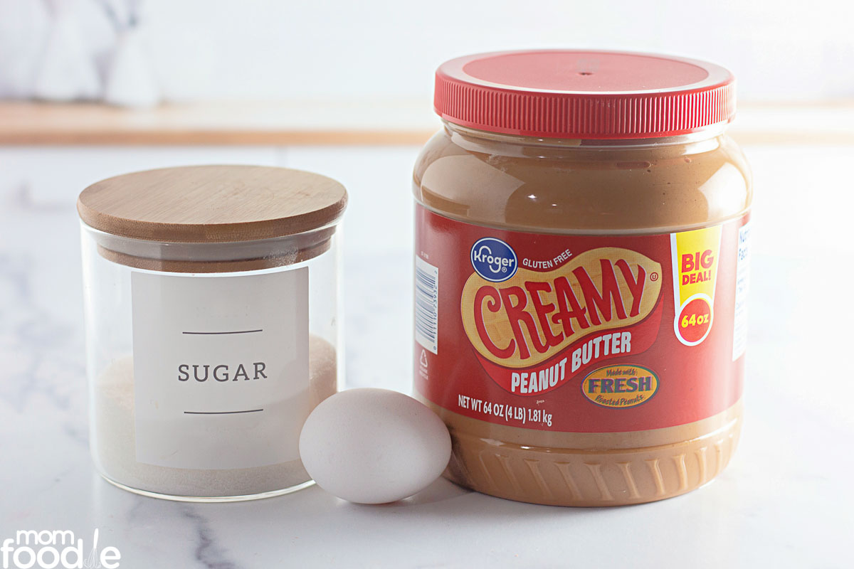 ingredients for the cookies; sugar, peanut butter and an egg.